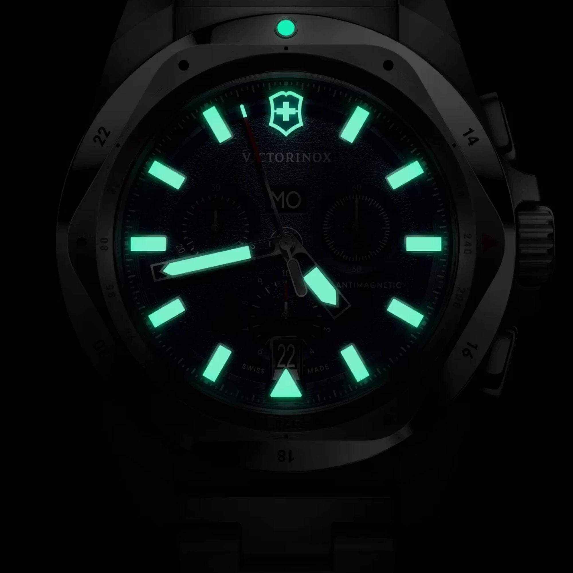 Victorinox I.N.O.X. 241985 blue dial chronograph watch with bright green lume hands and markers glowing in the dark