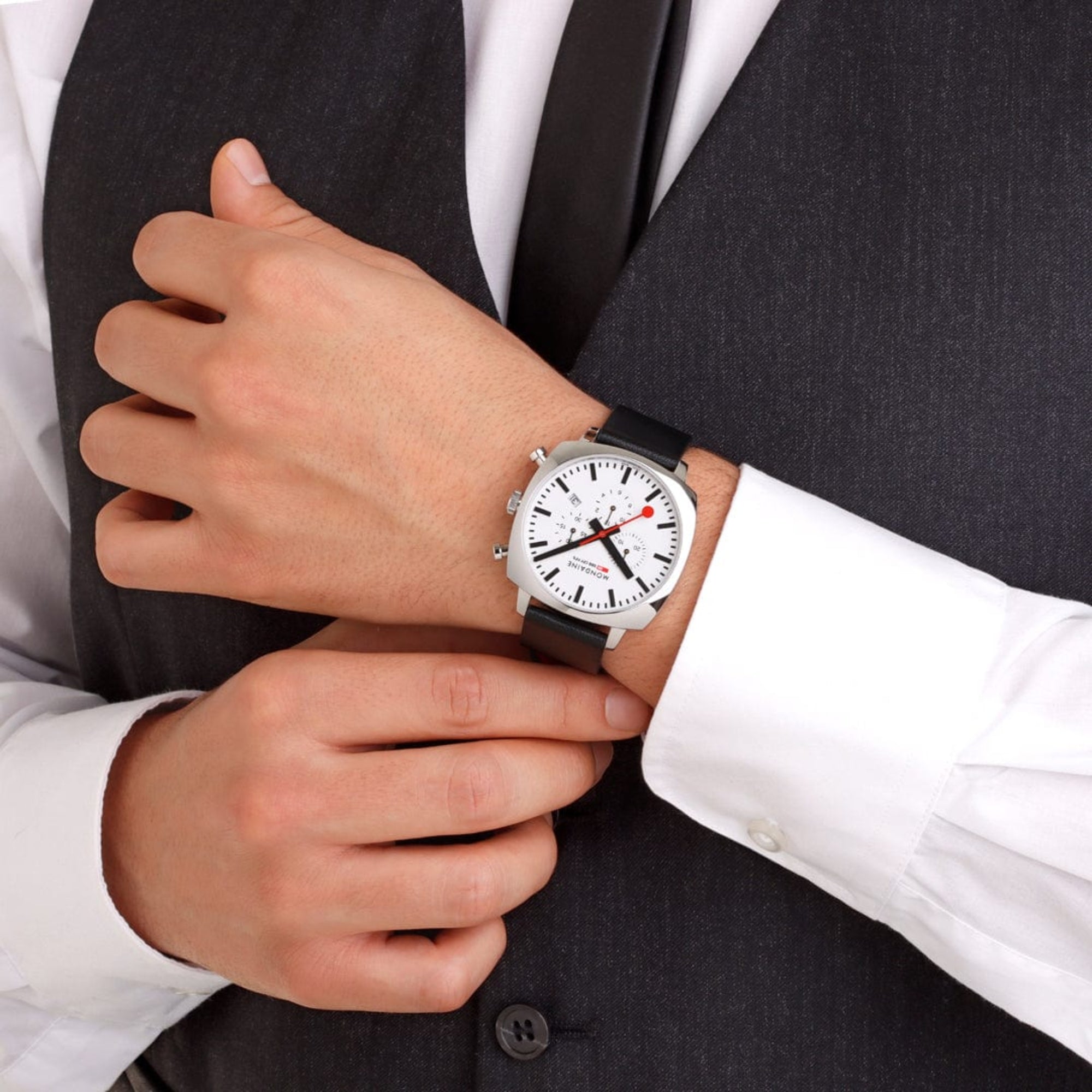 Mondaine Grand Cushion MSL.41410.LBV.SET watch styled on wrist with black leather strap and formal suit