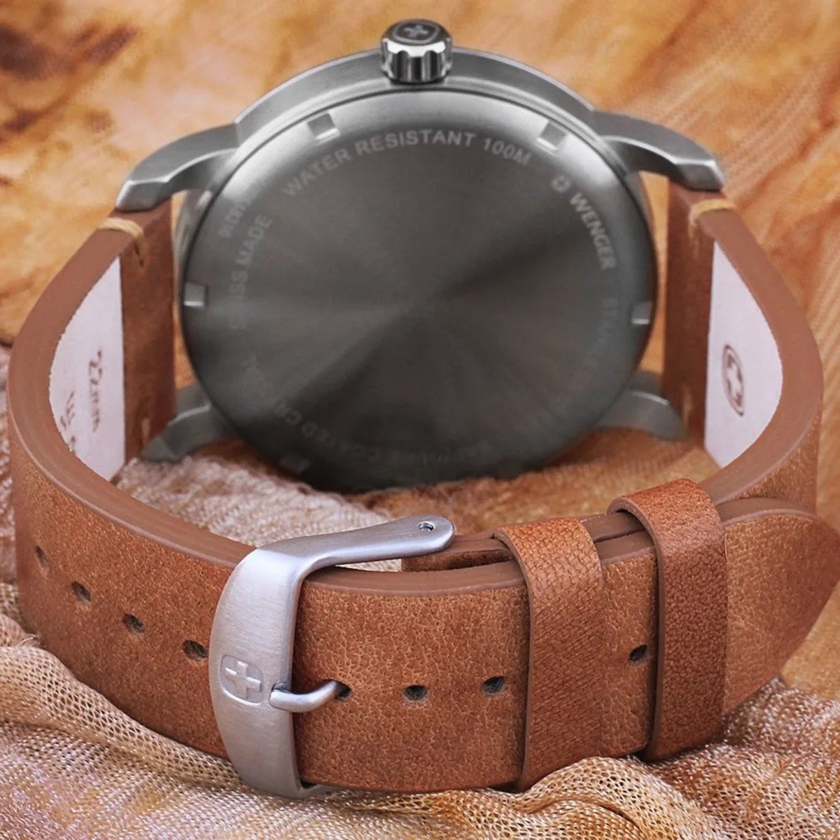 Wenger Attitude 01.1541.117 rear view showing solid engraved case back, leather strap underside, and pin buckle clasp