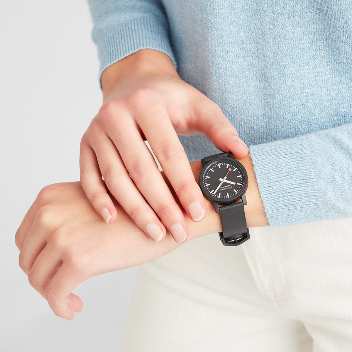 Mondaine Essence MS1.32120.RB wrist shot on a person wearing a light blue jumper