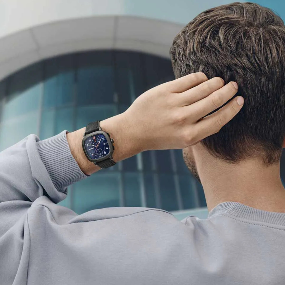Wenger Vintage Sport Chrono 01.1933.113 lifestyle shot of blue dial cushion watch on wrist with black silicone strap