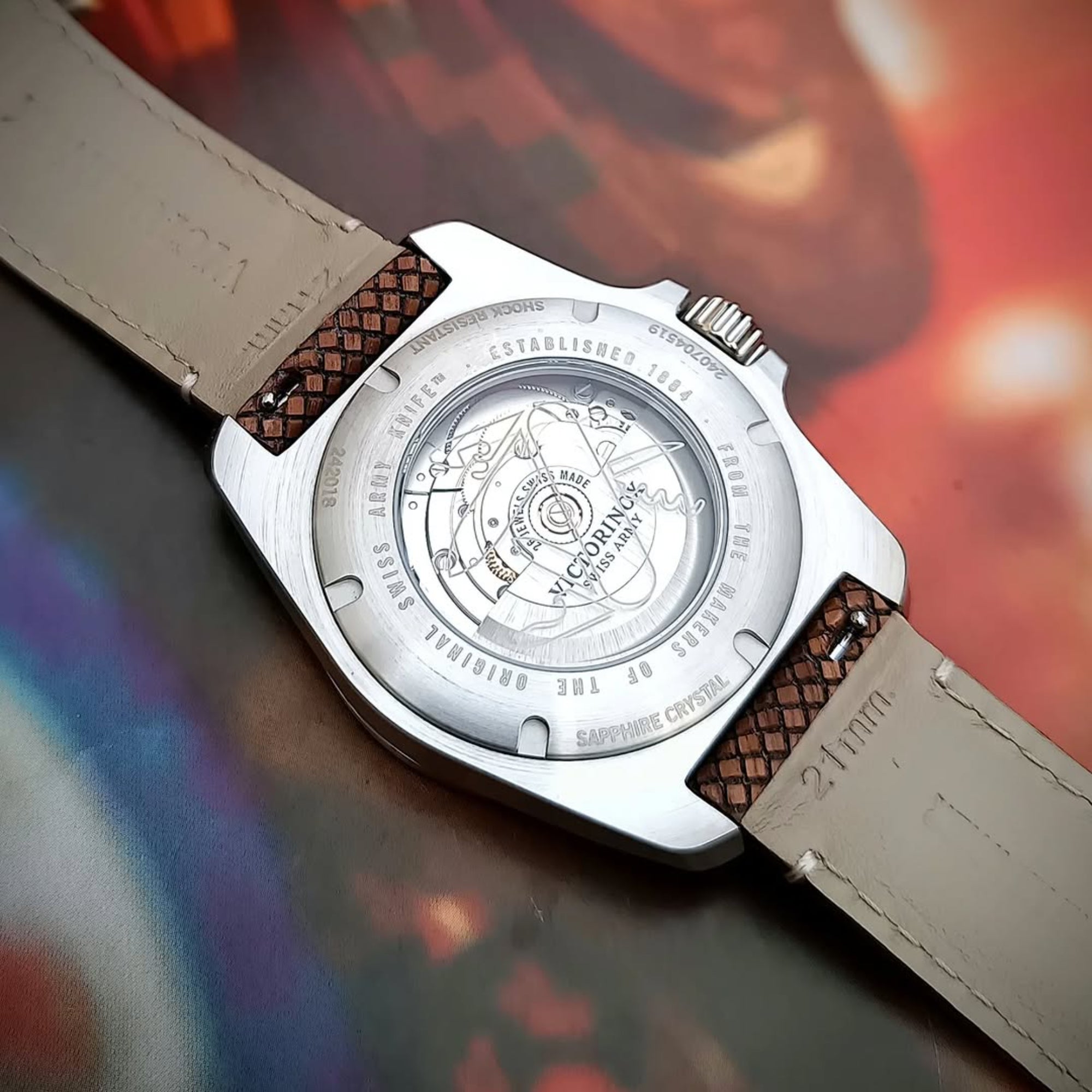The caseback view of a stainless steel Victorinox I.N.O.X. watch featuring an exhibition window showing the automatic movement