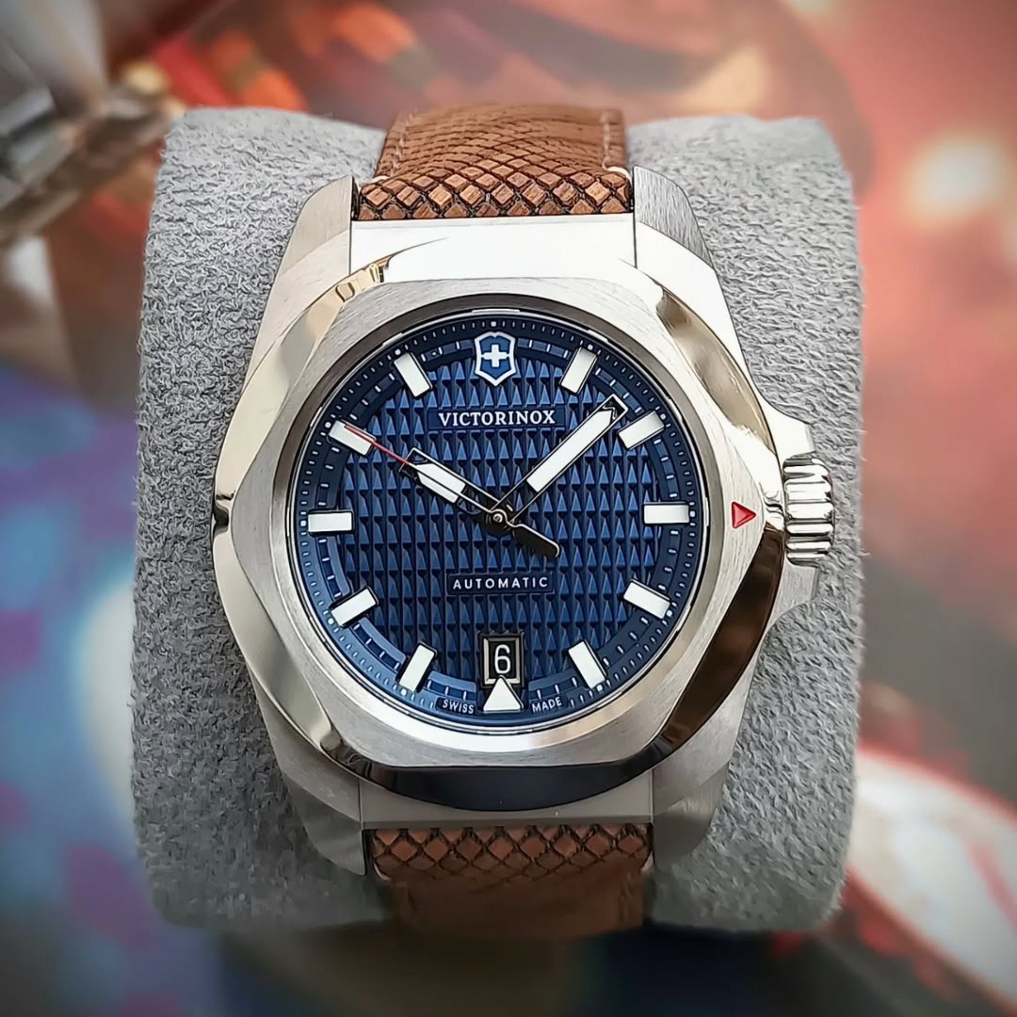 Victorinox I.N.O.X. 41mm Automatic blue dial wood strap watch 242018.1 resting on a gray display cushion