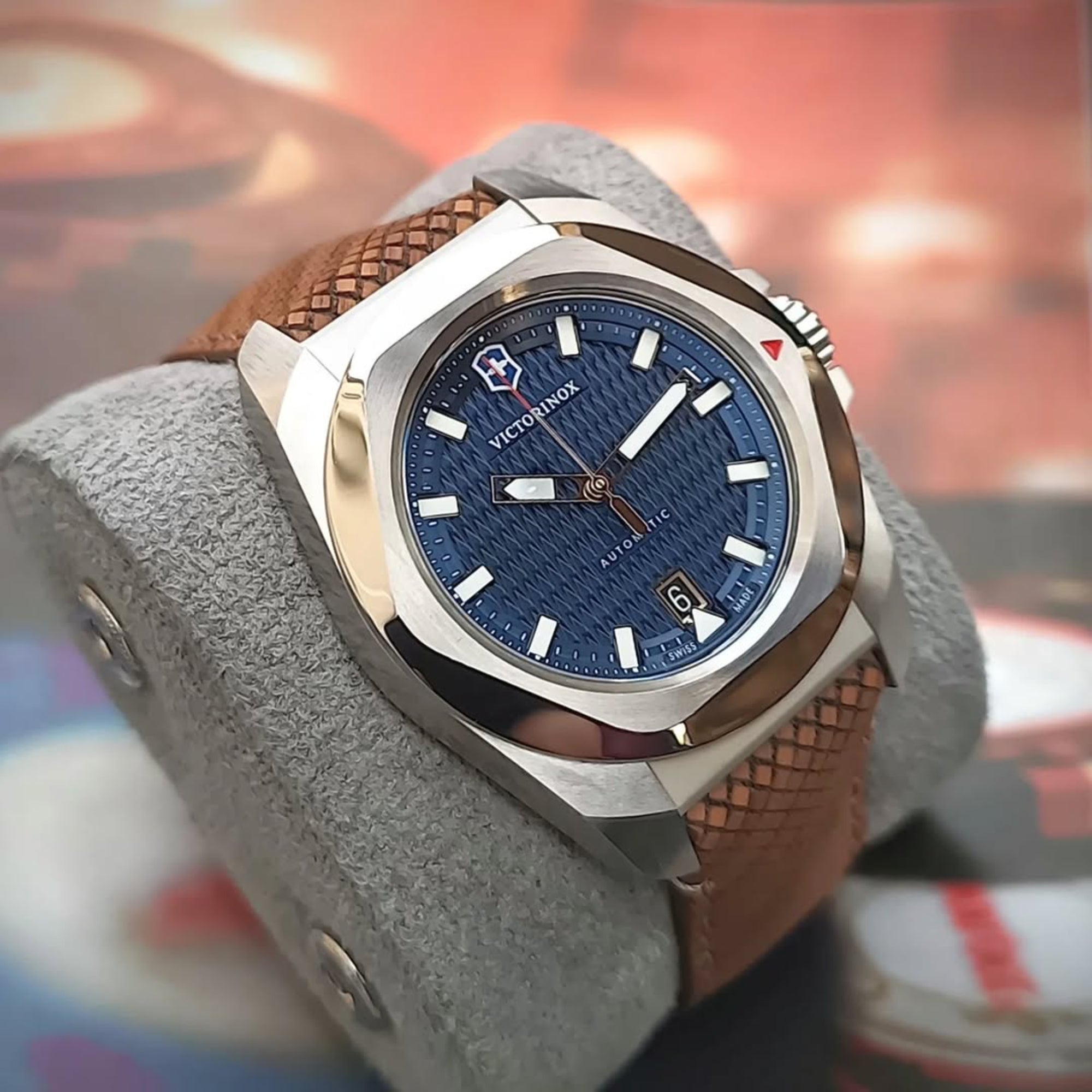 Victorinox I.N.O.X. 41mm Automatic blue dial wood strap watch 242018.1 resting on a gray display cushion