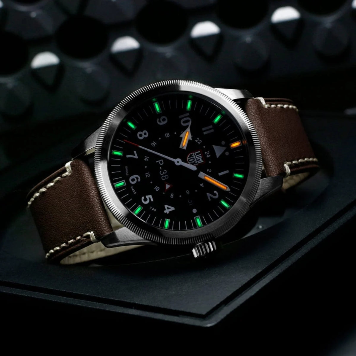 Luminox P-38 Lightning Air Pilot 9520 Series XA.9521 black dial mens watch shot angled on presentation stand displaying glowing night vision tritium tubes
