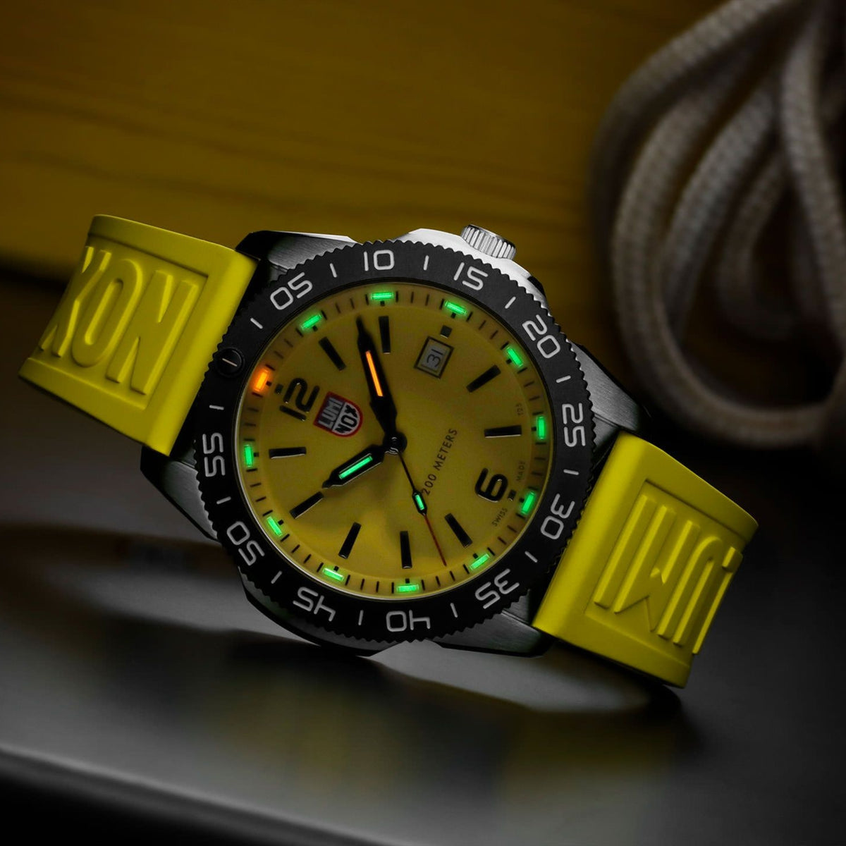 Luminox Pacific Diver 3120 Series XS.3125 angled view in low light displaying illuminated gas tubes on yellow dial