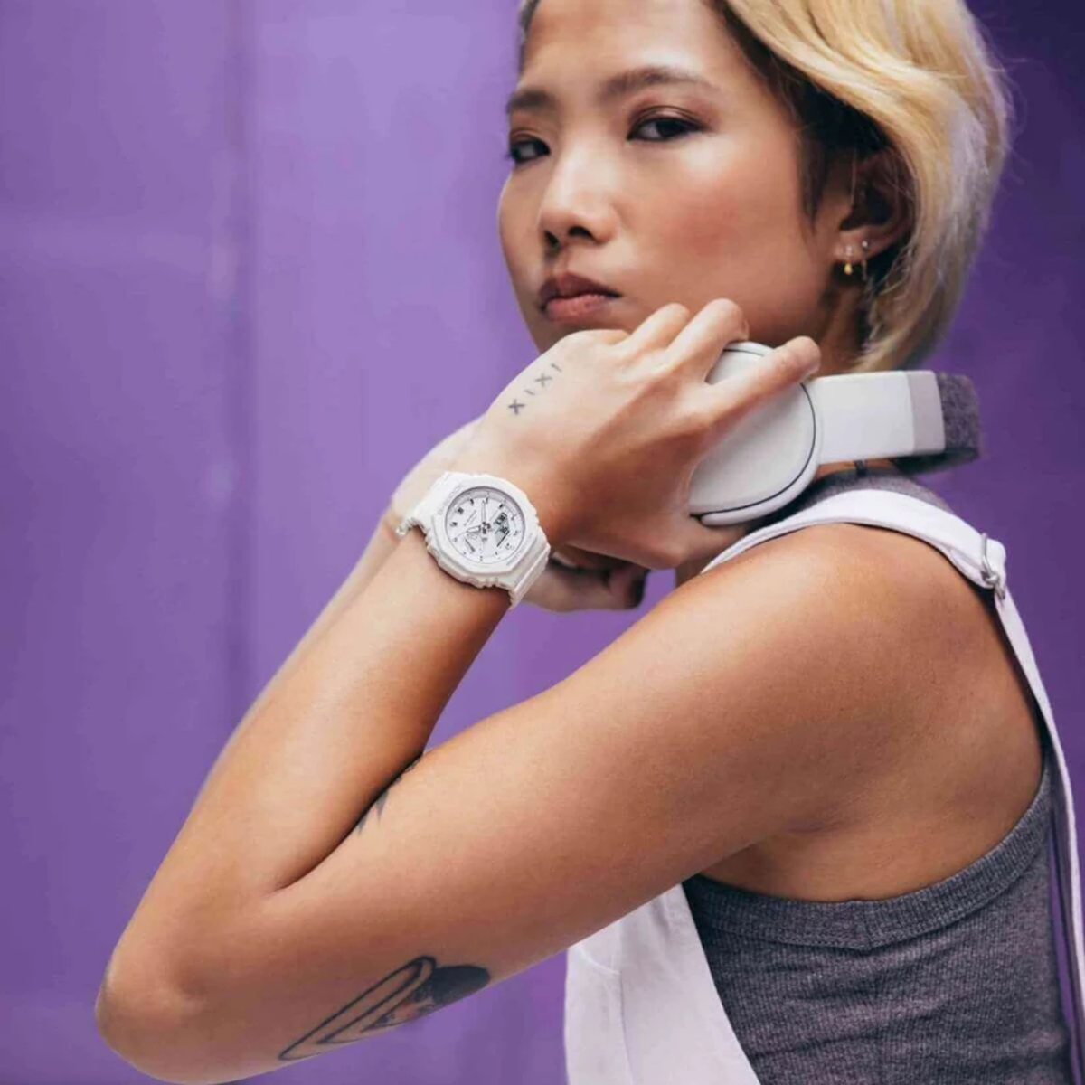 Casio G-Shock GMA-S2100-7AER model lifestyle shot highlighting white resin watch against a vibrant background