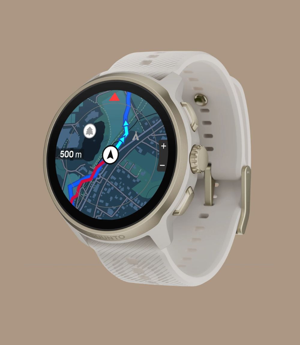 Suunto smartwatch showing map navigation screen with gold-tone bezel and white silicone strap