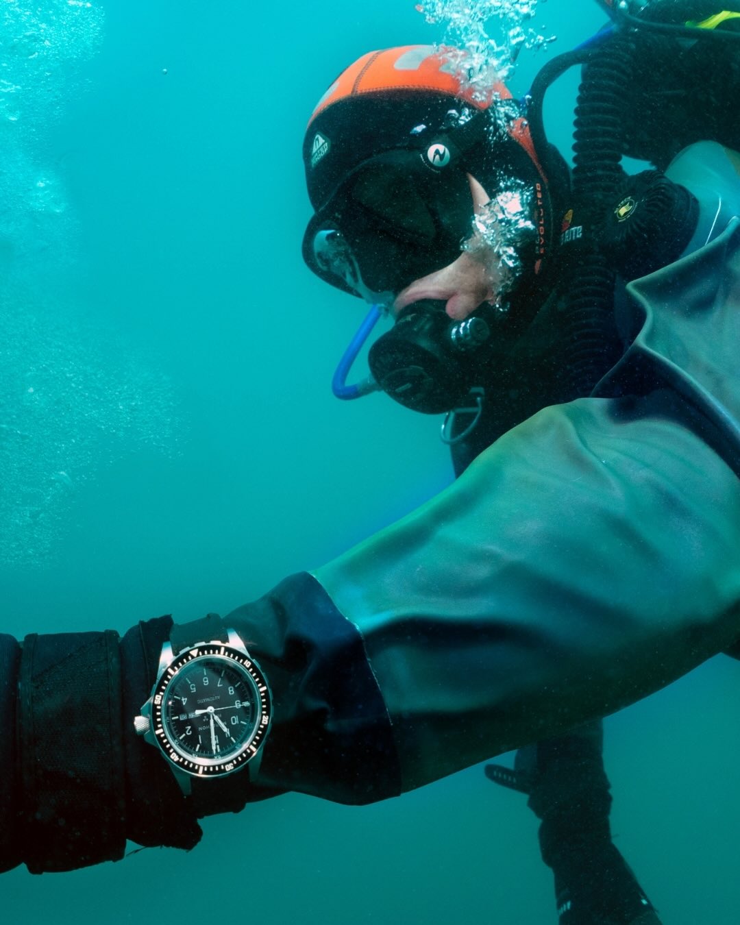 Marathon automatic watch on rubber strap worn on wrist underwater by scuba diver