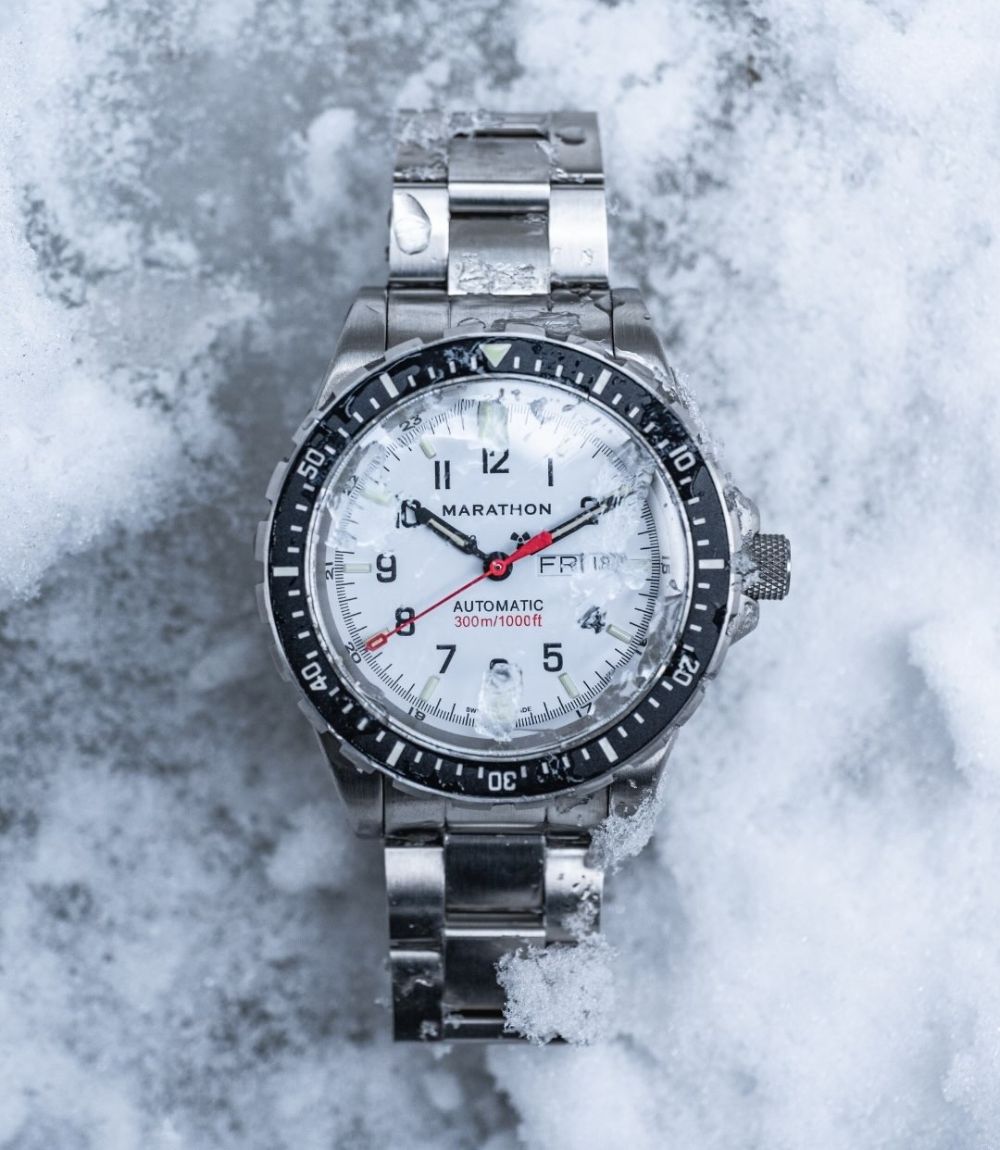 Marathon Search & Rescue Arctic automatic watch on steel bracelet resting on snow and ice background