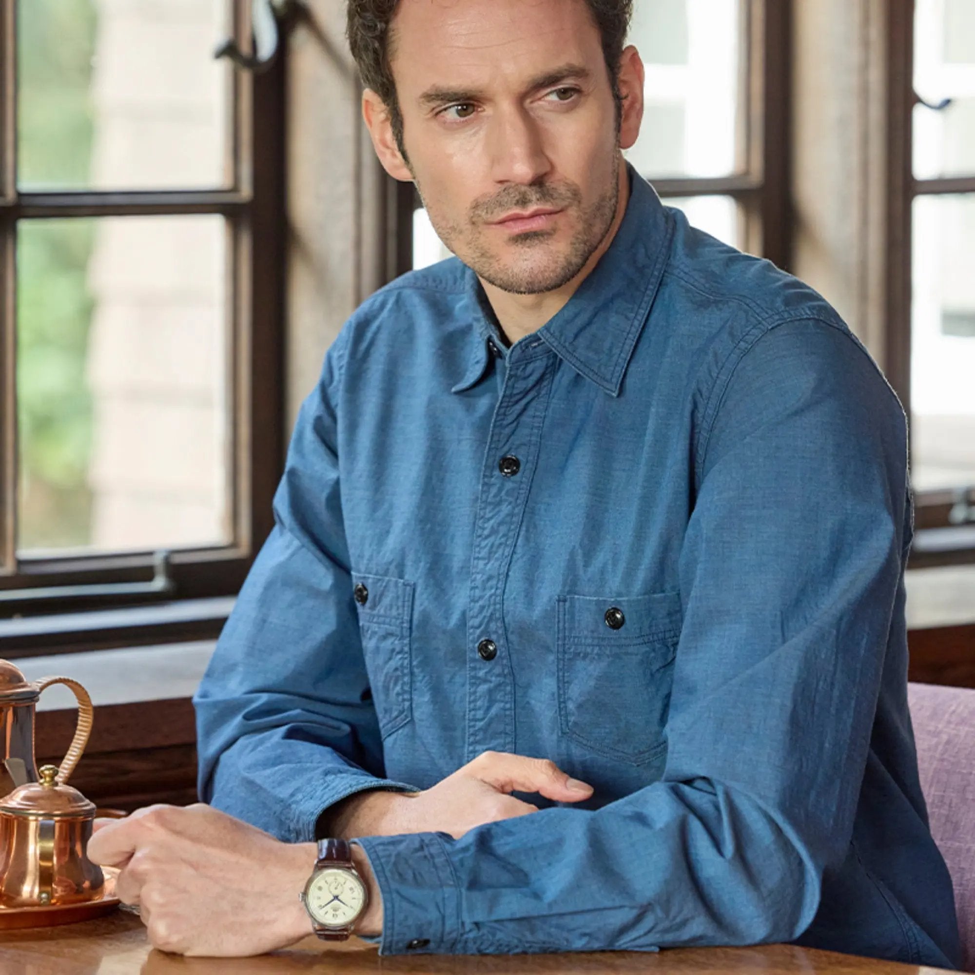 Model wearing the Orient Bambino 38mm Small Seconds RA-AP0105Y30B automatic wrist watch with a champagne dial paired with a blue shirt.
