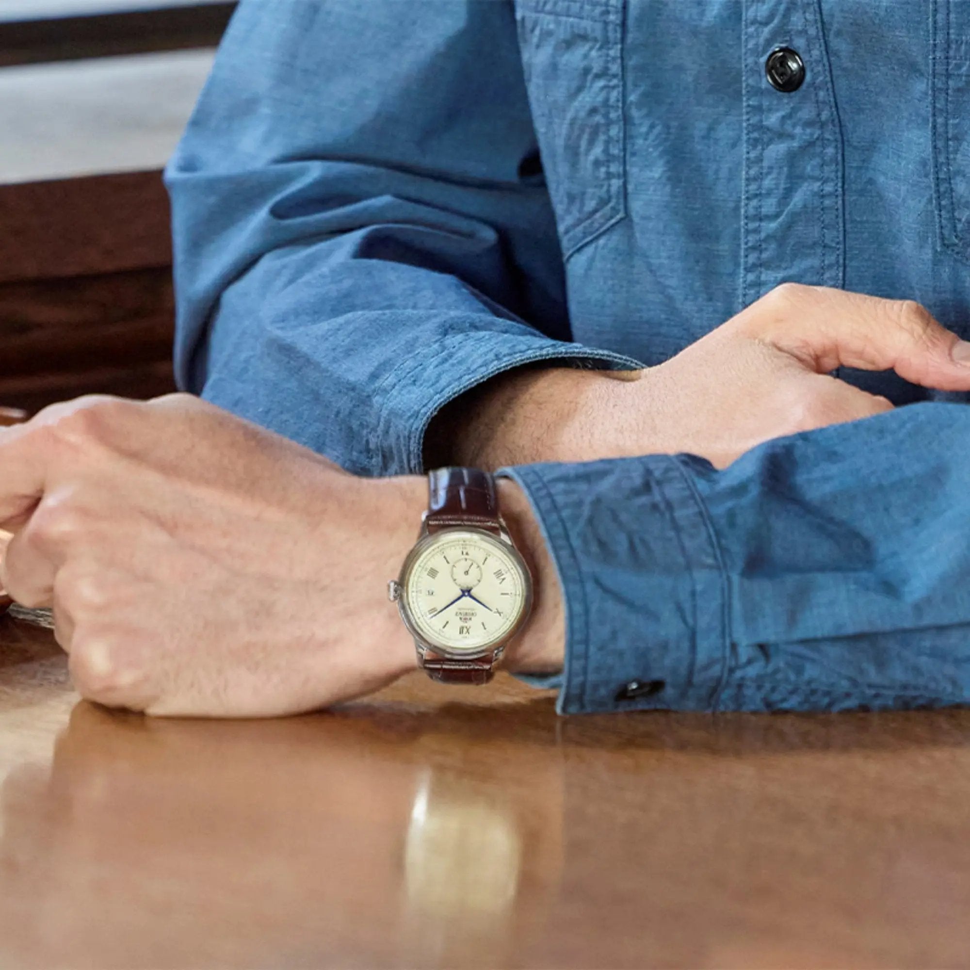 Orient Bambino 38mm Small Seconds RA-AP0105Y30B dress watch with champagne dial and brown leather strap worn on a wrist