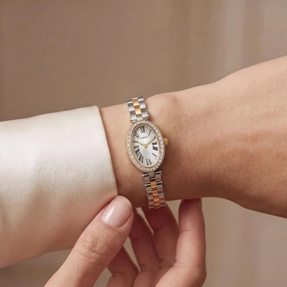 Timex Trend Cavatina TW2Y90200 wrist view showing silver dial quartz watch styled on a person wearing a two-tone steel bracelet