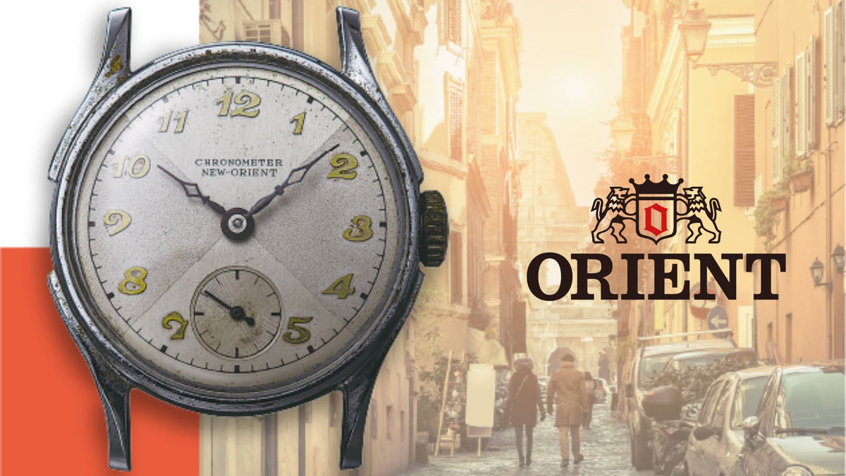 Orient Vintage Collection Chronometer New-Orient watch featuring a silver sector dial with small seconds subdial, yellowed numerals, and brand logo over a street scene background