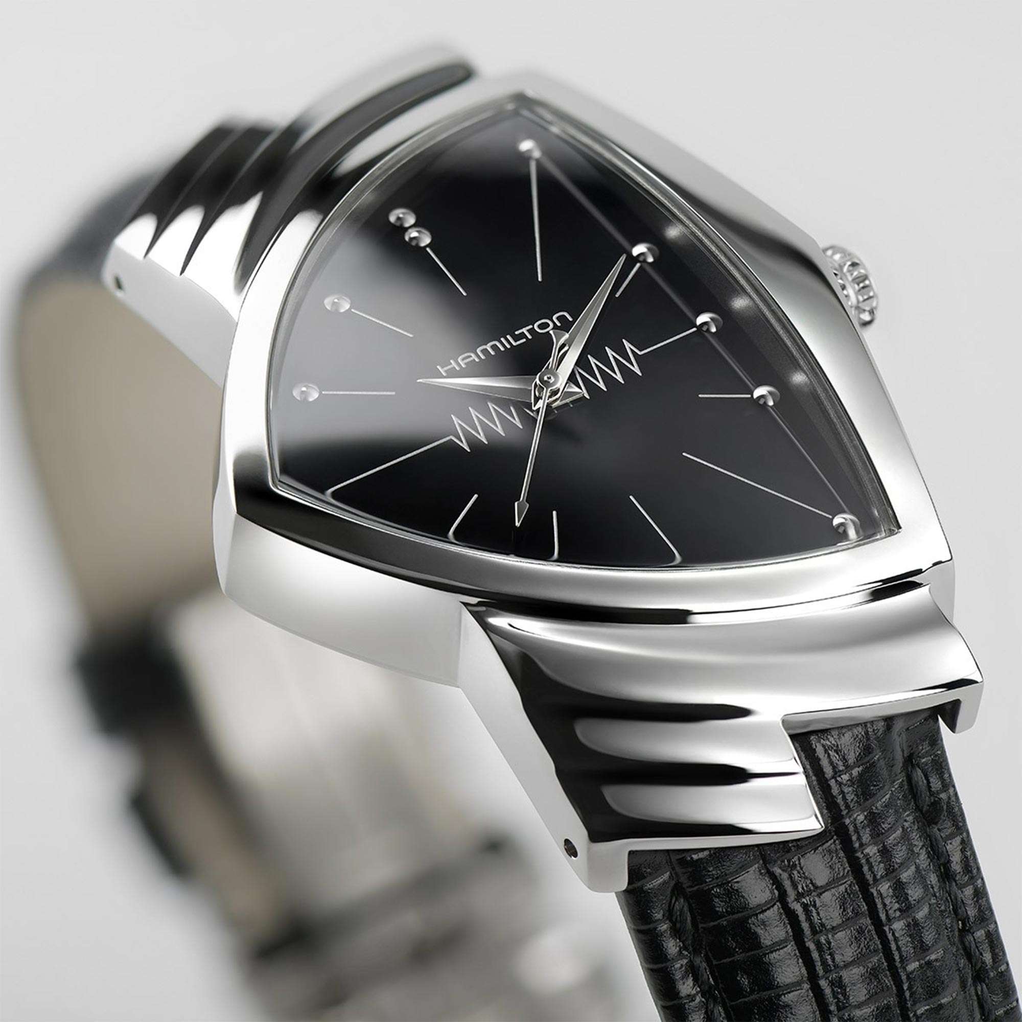 Side view of a Hamilton Ventura watch showcasing its unique triangular case, black dial, and black leather strap