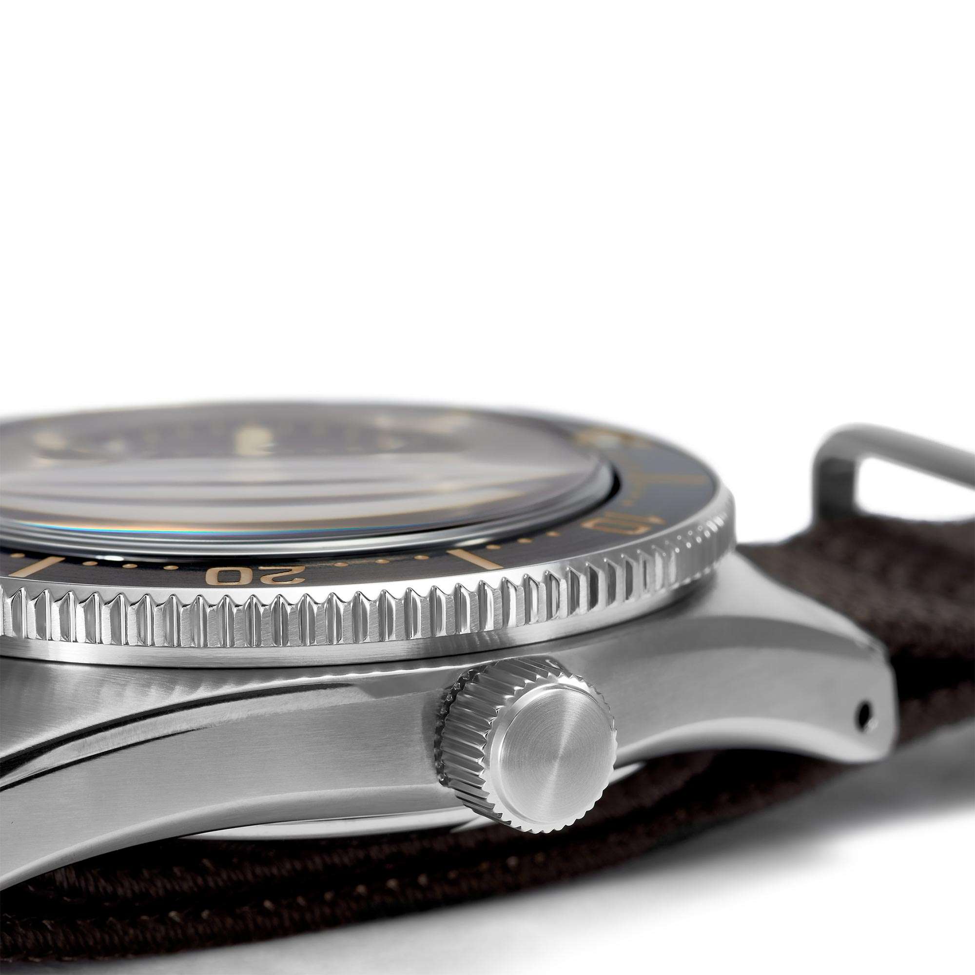 Close-up of a silver watch with a brown strap on a white background