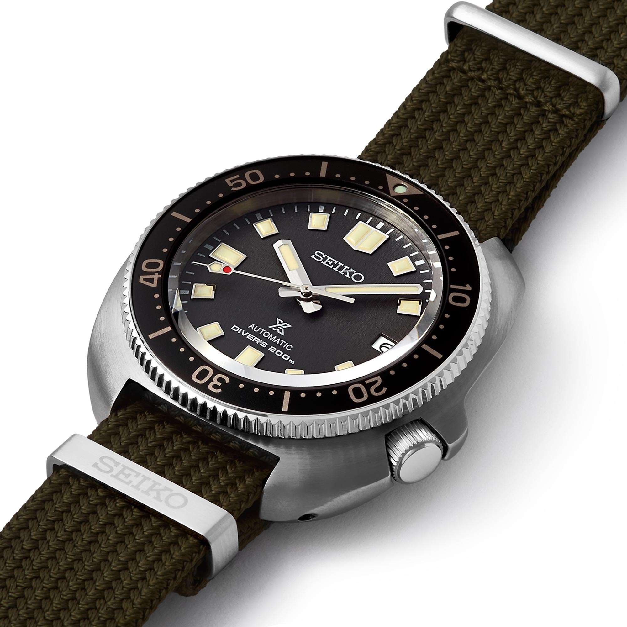 Seiko watch with brown strap and black dial on a white background