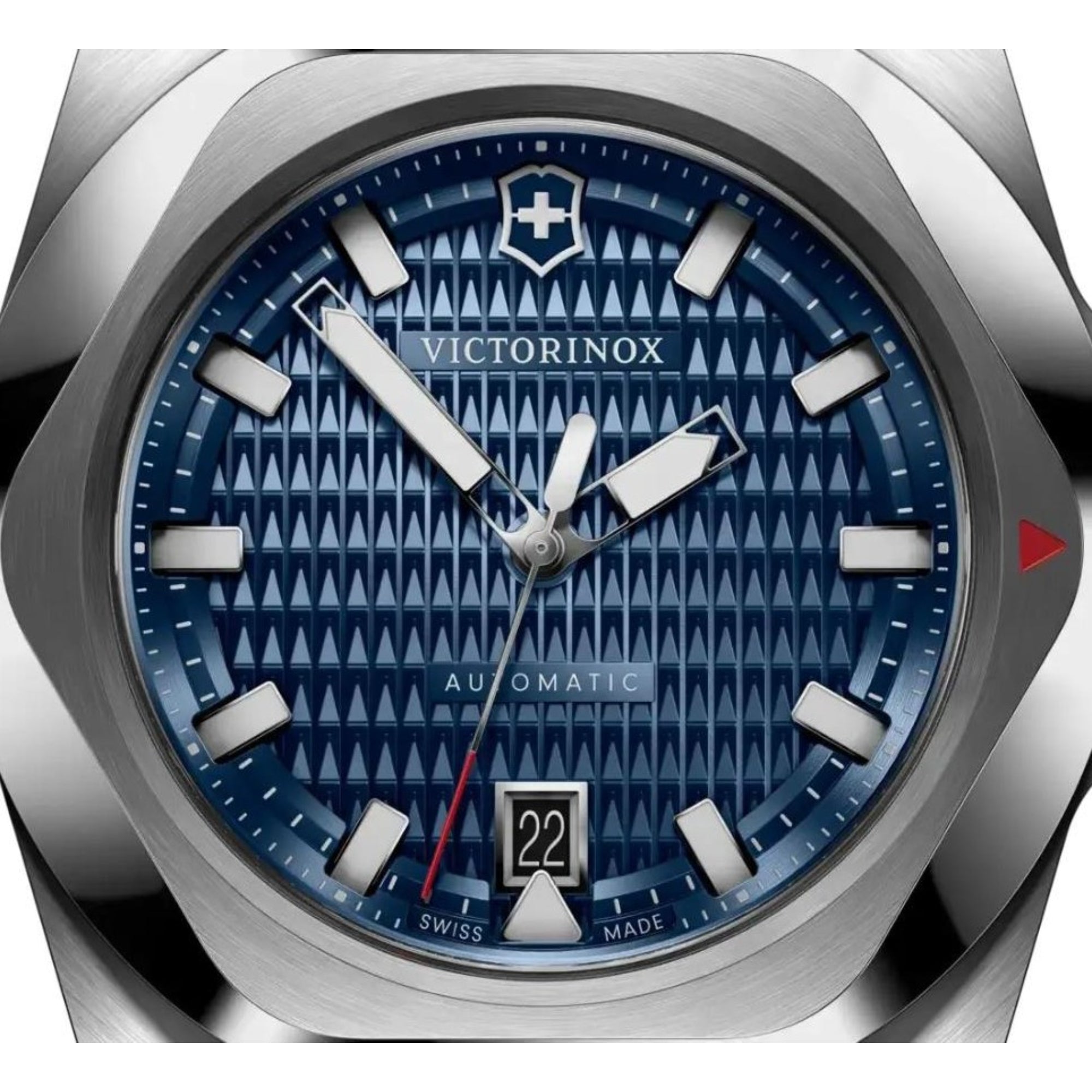 A close-up shot of a stainless steel Victorinox watch featuring a textured blue dial with white hour markers and a date window