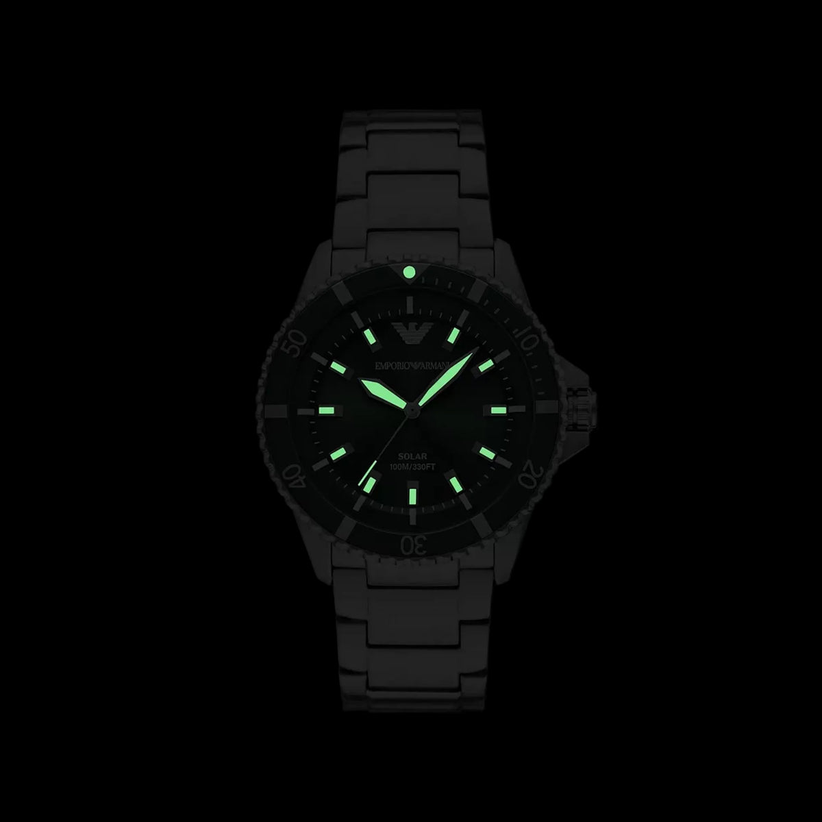 Emporio Armani World Explorer AR11698 timepiece with glowing green luminous hands and hour markers in the dark