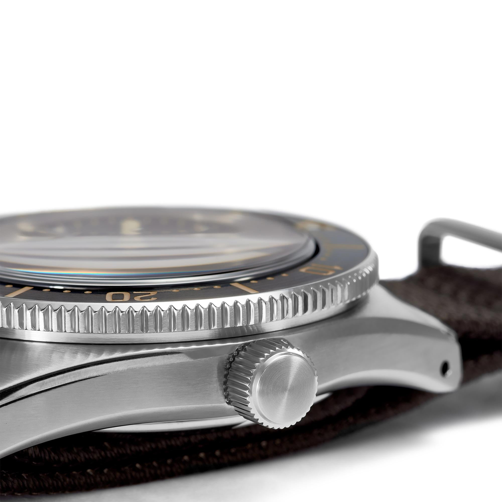 Close-up of a silver watch with a brown leather strap on a white background