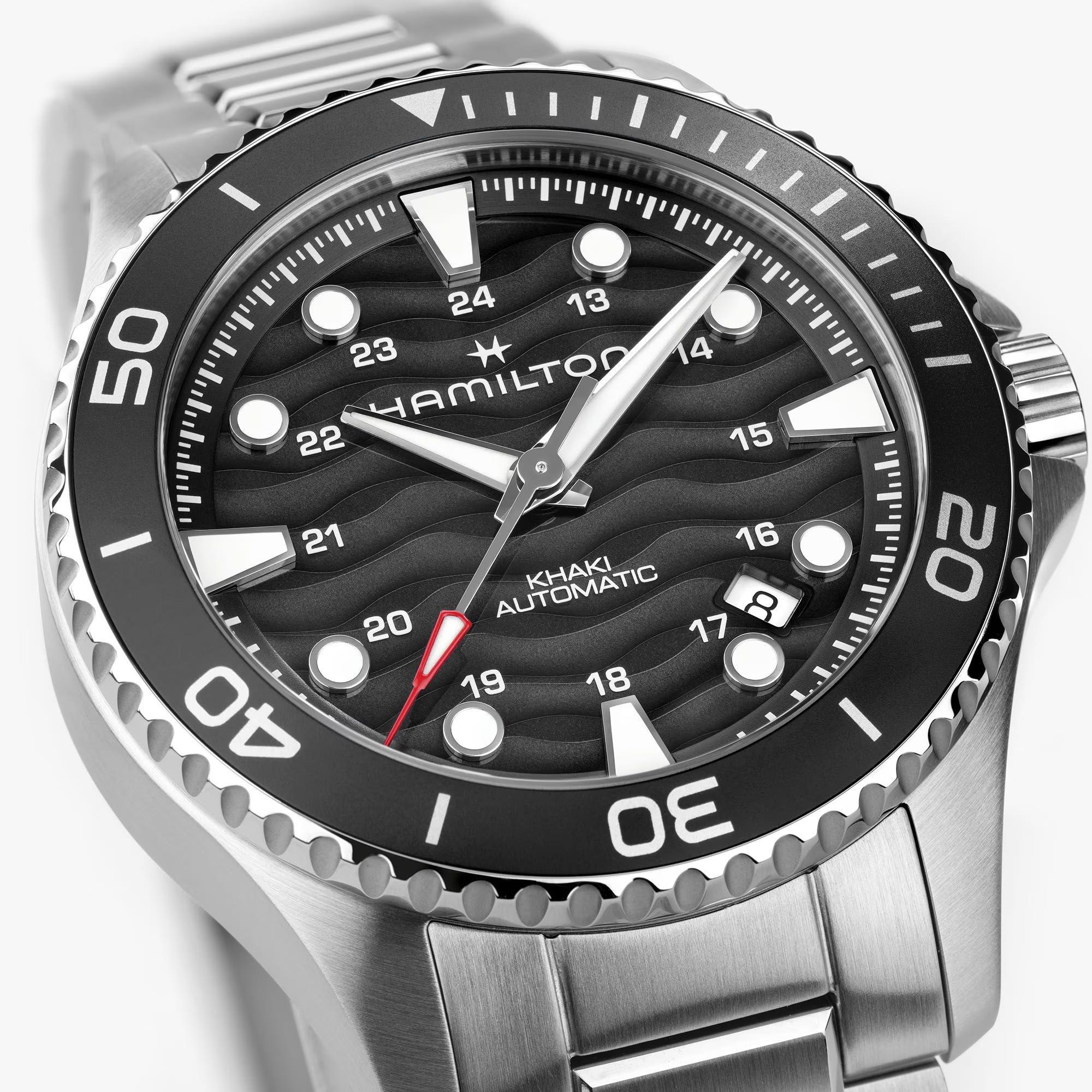 Stainless steel dive watch face, black dial with luminous markers and date window