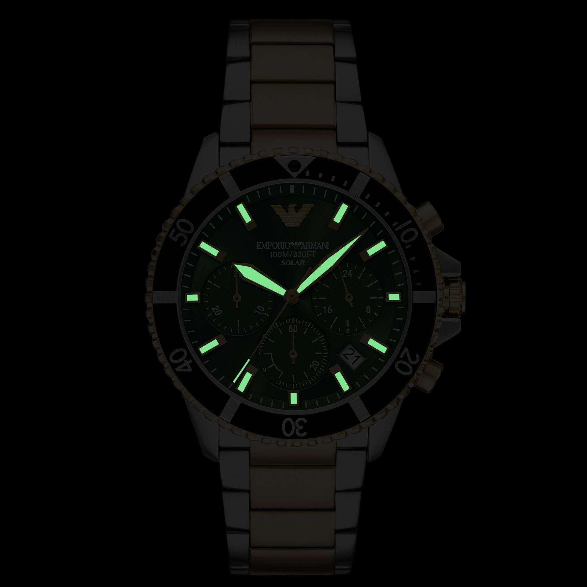 Solar chronograph watch with green dial and luminous markers on steel bracelet