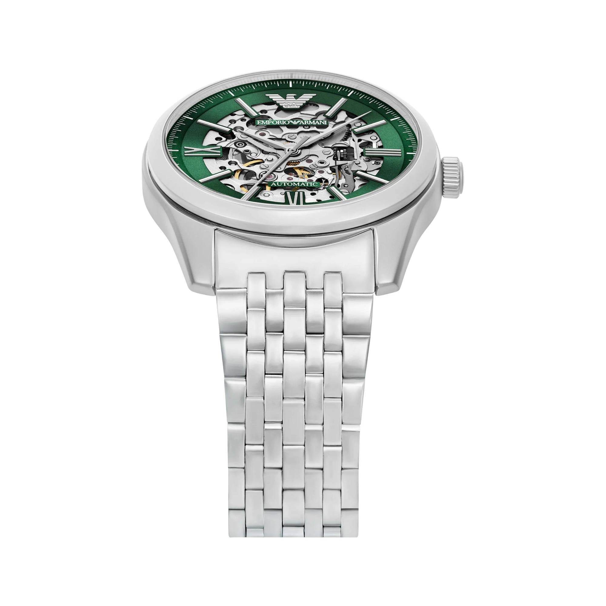 Steel automatic skeleton watch with green dial and see-through movement, angled front.