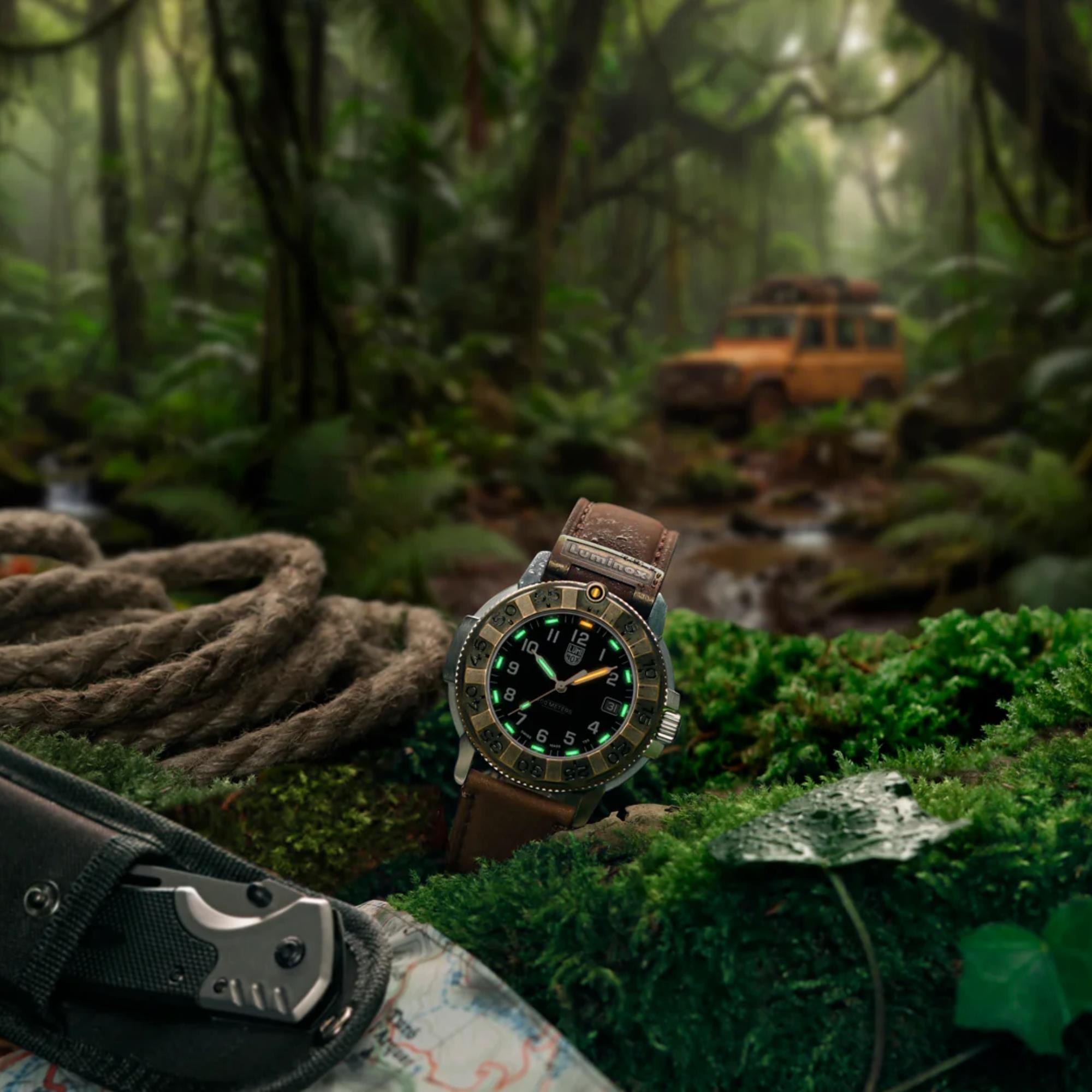 The Luminox Adventure black dial watch XL.1301.LG rests on a bed of green moss in a dense jungle, showing its glowing green and orange hands