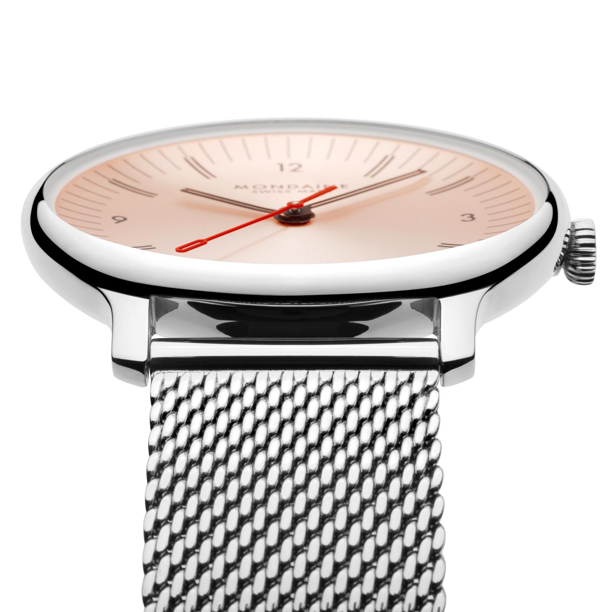 A close-up, low-angle side view of the watch head, accentuating the polished silver finish of the bezel, the distinctively thin case profile, and the texture of the integrated stainless steel mesh band