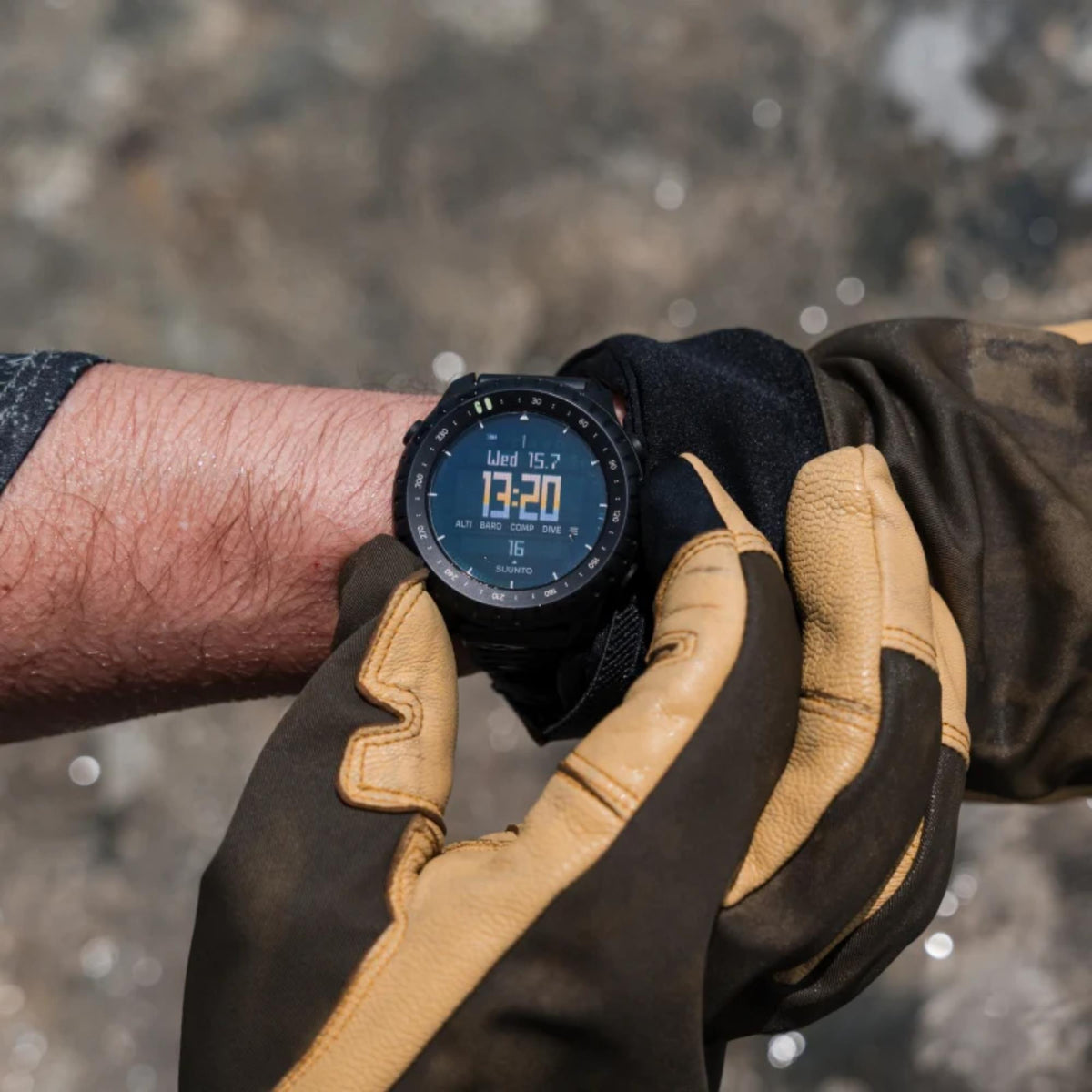 Suunto Core SS051780000 close-up wrist shot while wearing protective outdoor gloves
