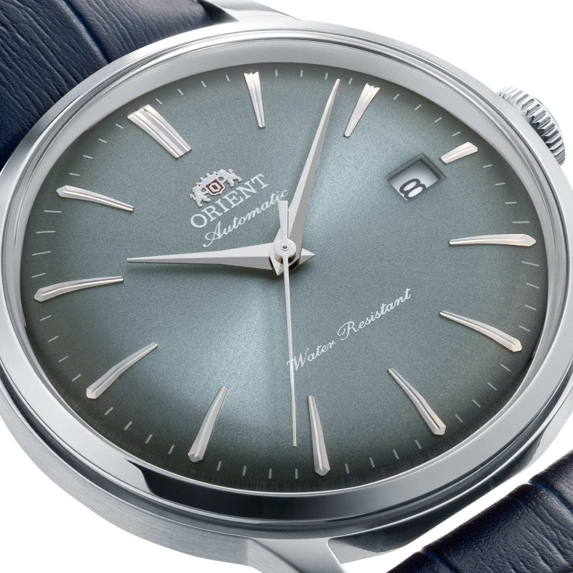 Close-up of an Orient Bambino automatic watch featuring a blue dial and a leather strap.