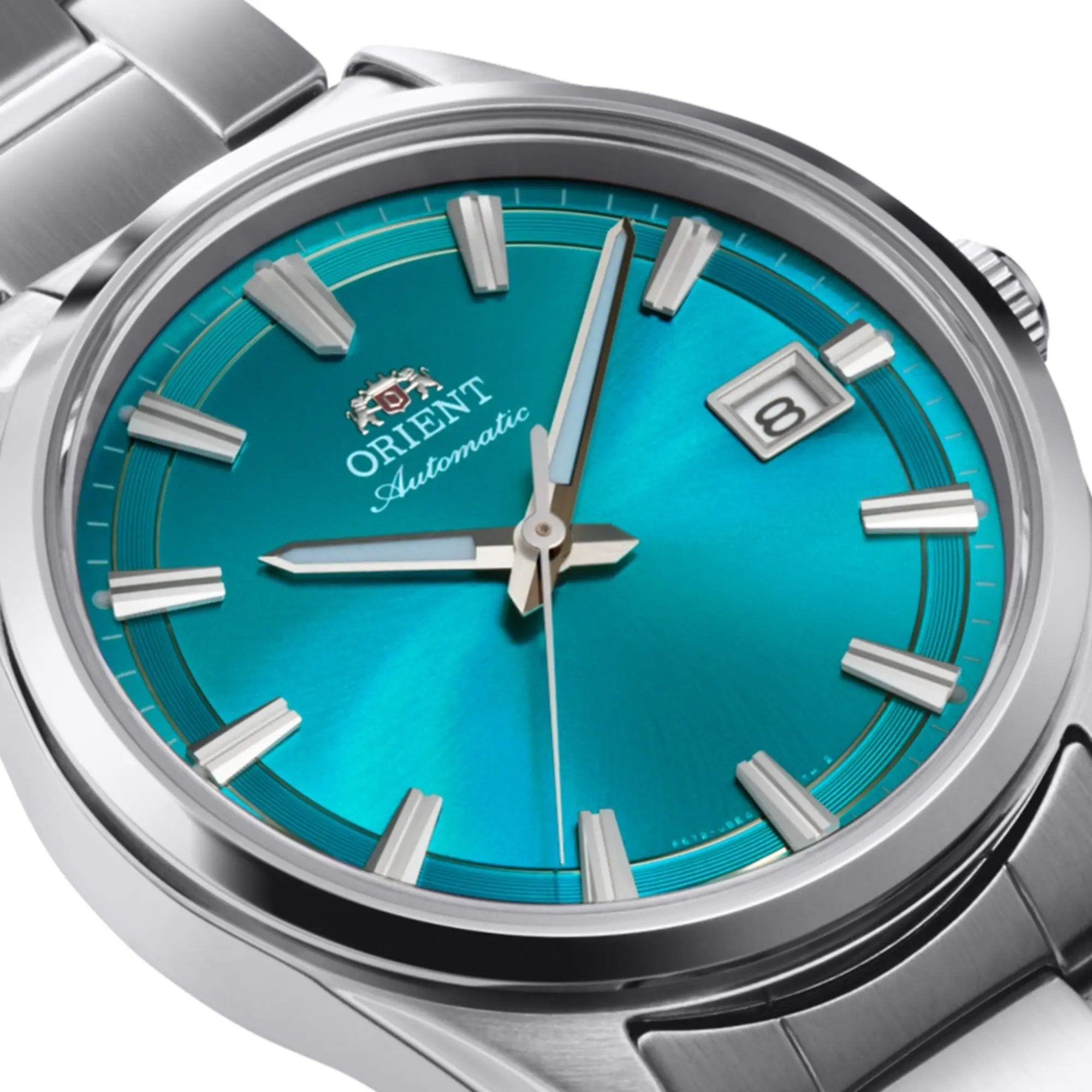 Close-up of an Orient Stretto automatic watch with a vibrant blue dial and stainless steel bracelet.