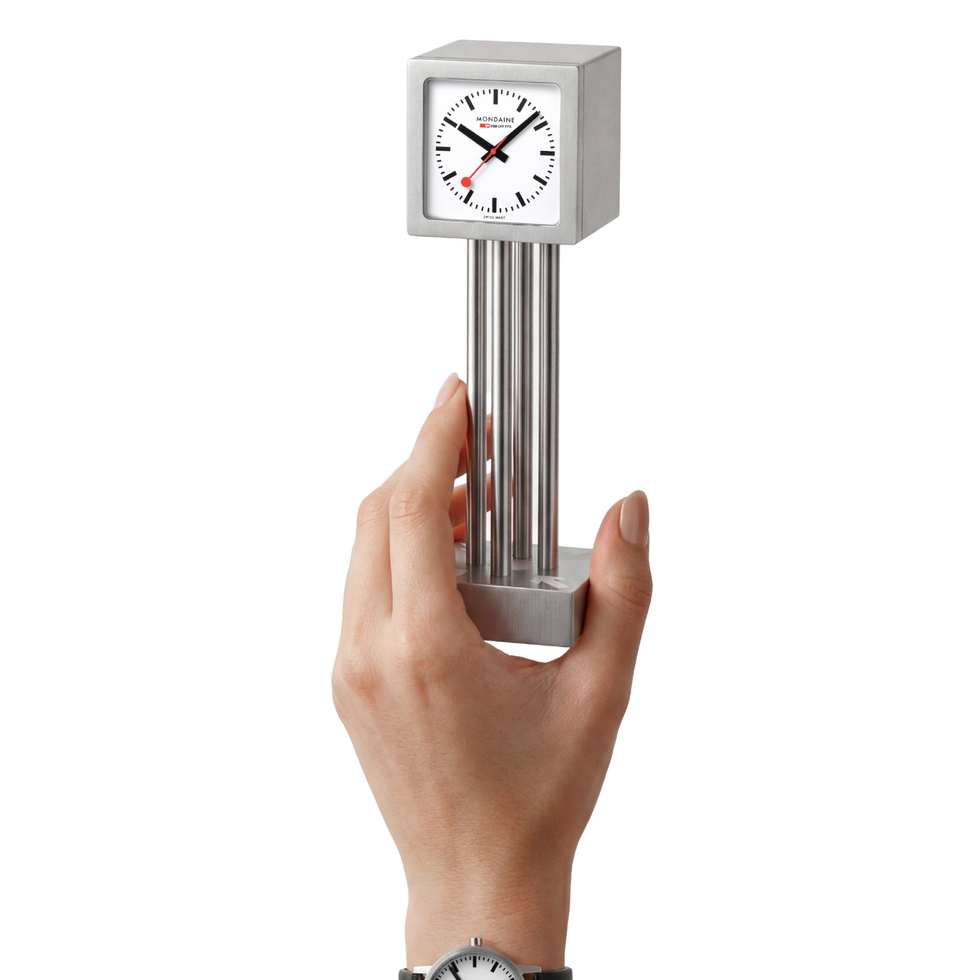 Mini table clock held from the bottom, brushed aluminum finish