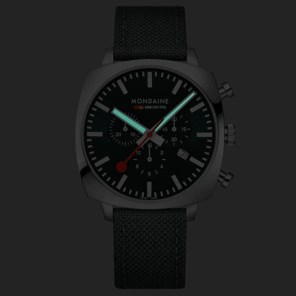 Mondaine Cushion MSL.41460.LF.SET low light perspective highlighting luminous hands on green dial face