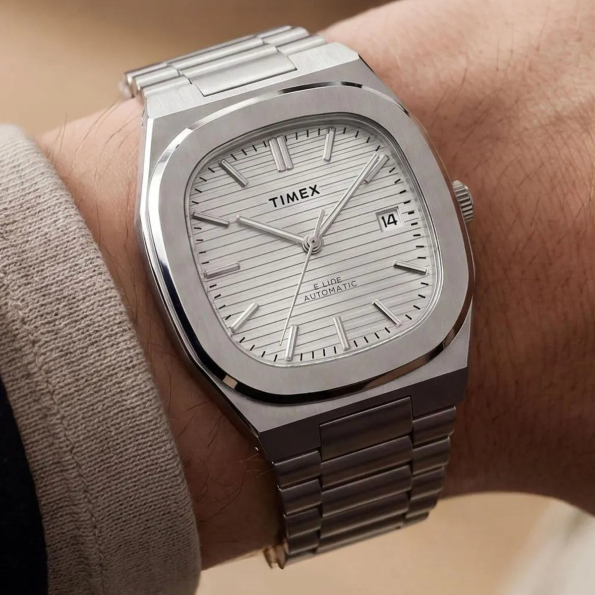 Timex E Line TW6A00500 wrist view showing a silver dial automatic watch styled on a person wearing a steel bracelet
