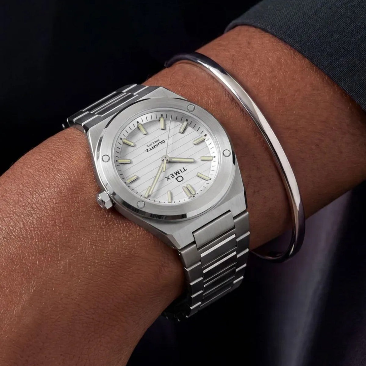 Q Timex Marbella TW2Y81800 wrist view showing a silver dial ladies watch styled on a person wearing a steel bracelet