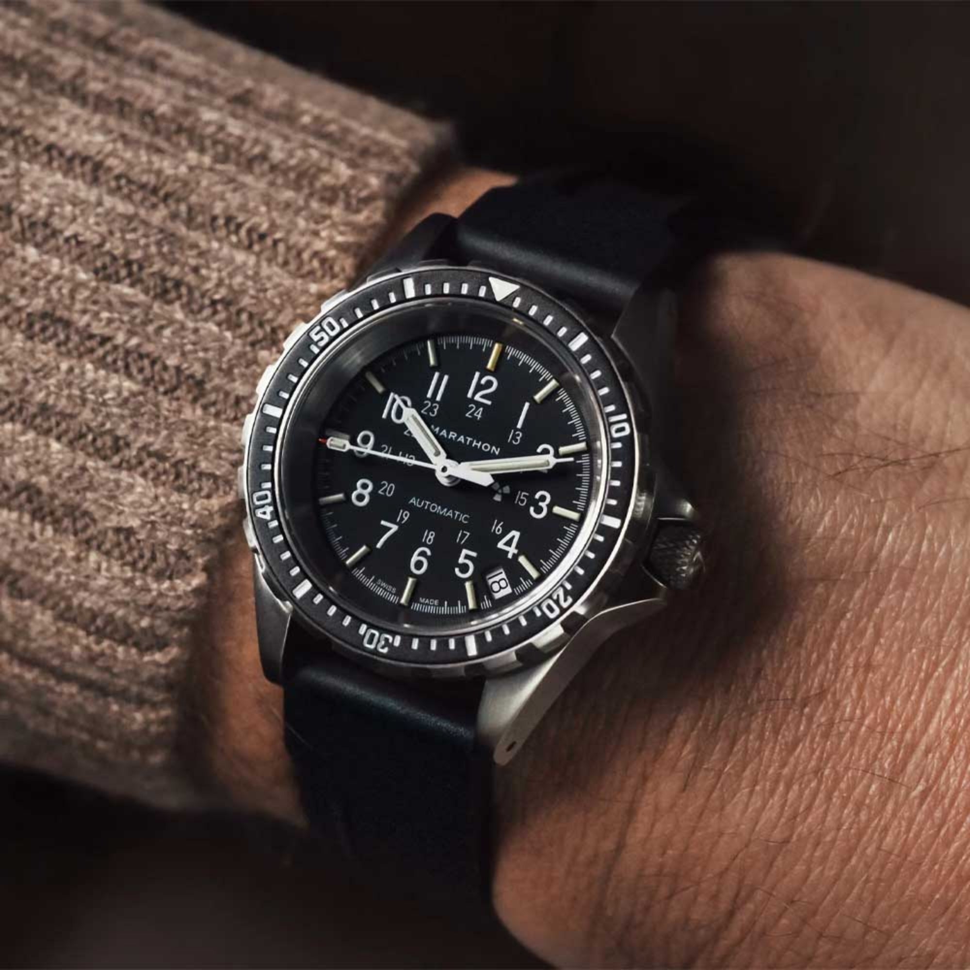 Marathon automatic diver’s watch on wrist with black dial and black rubber strap