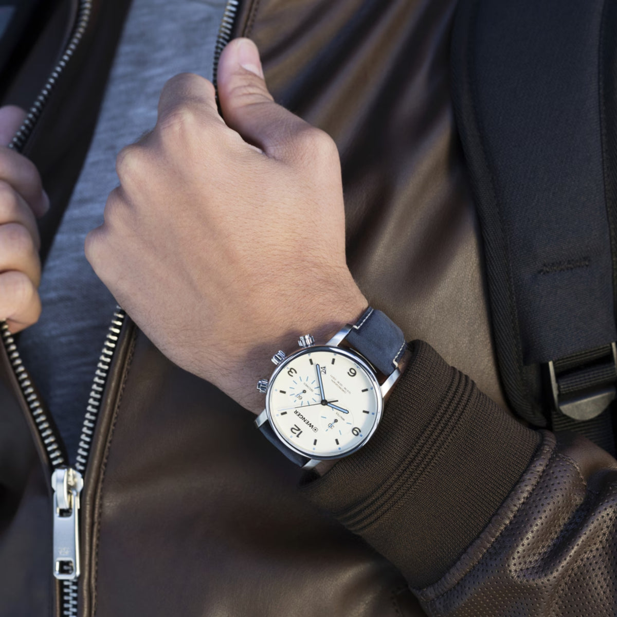 Wenger Urban Metropolitan 01.1743.119 lifestyle wrist view featuring cream dial face, steel case, and leather strap