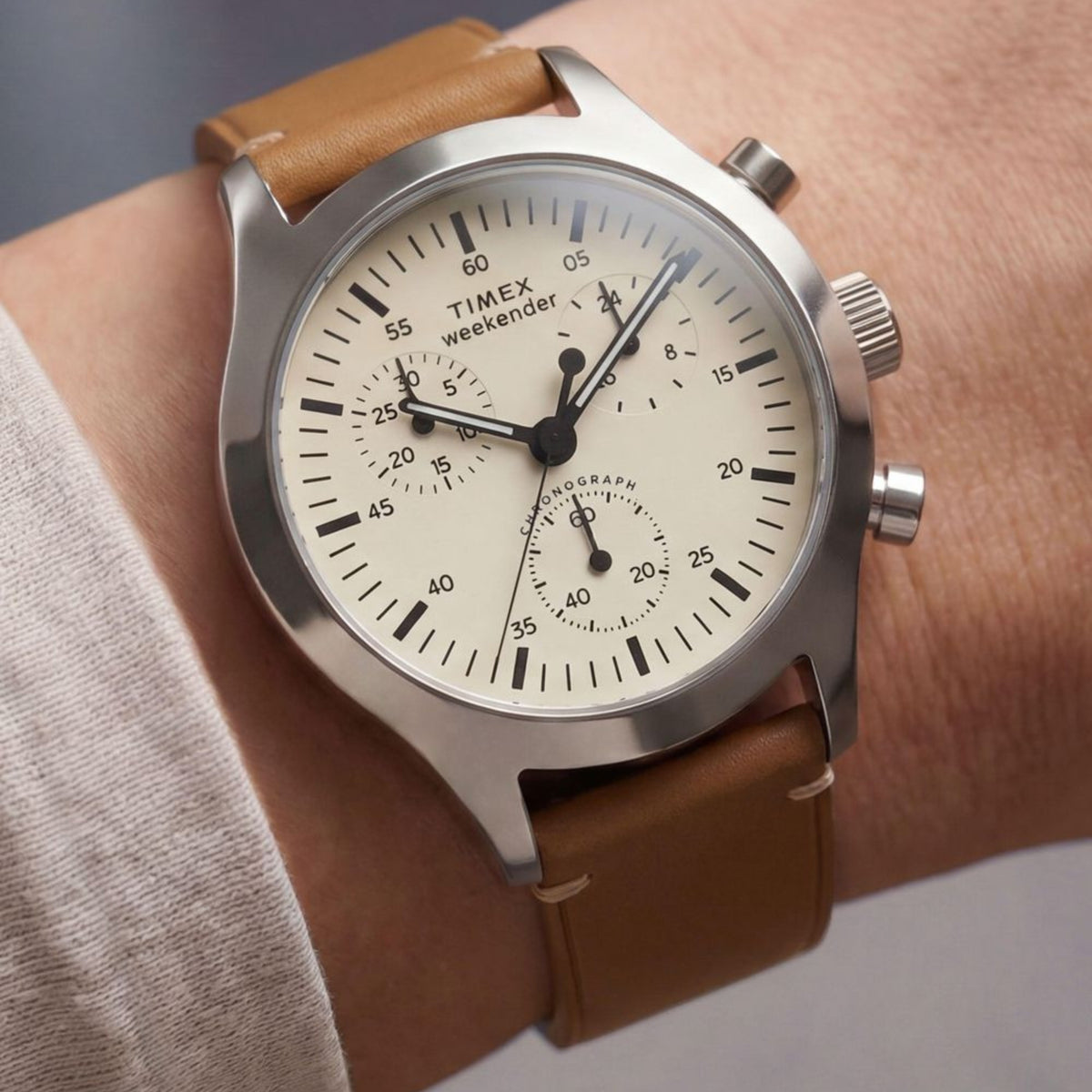 Timex Weekender New England TW2Y85000 wrist view showing cream dial quartz watch styled on a person wearing a leather strap