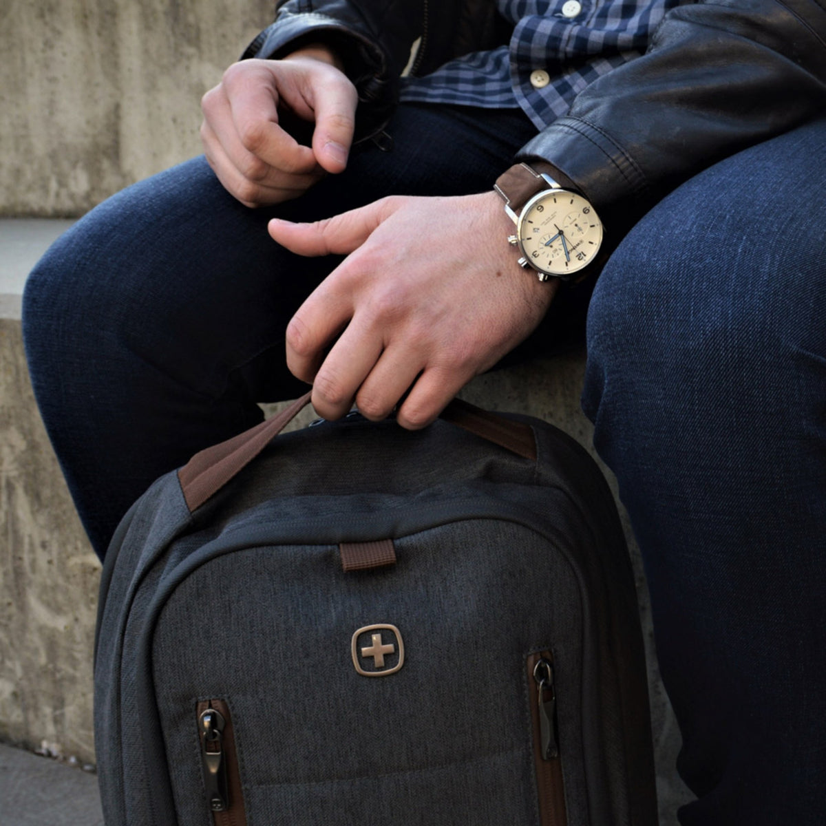 Wenger Urban Metropolitan Chronograph 01.1743.111 lifestyle shot featuring cream dial watch on wrist with a grey backpack