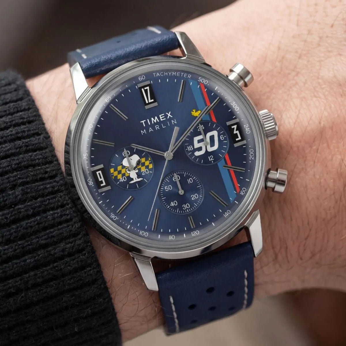 Timex Peanuts x Marlin TW2Y85300 wrist view showing blue dial chronograph watch styled on a person wearing a leather strap