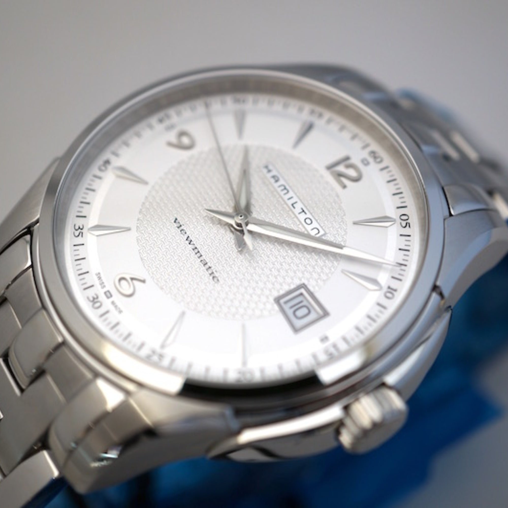 Silver dial men's stainless steel watch with date window at 6 o'clock