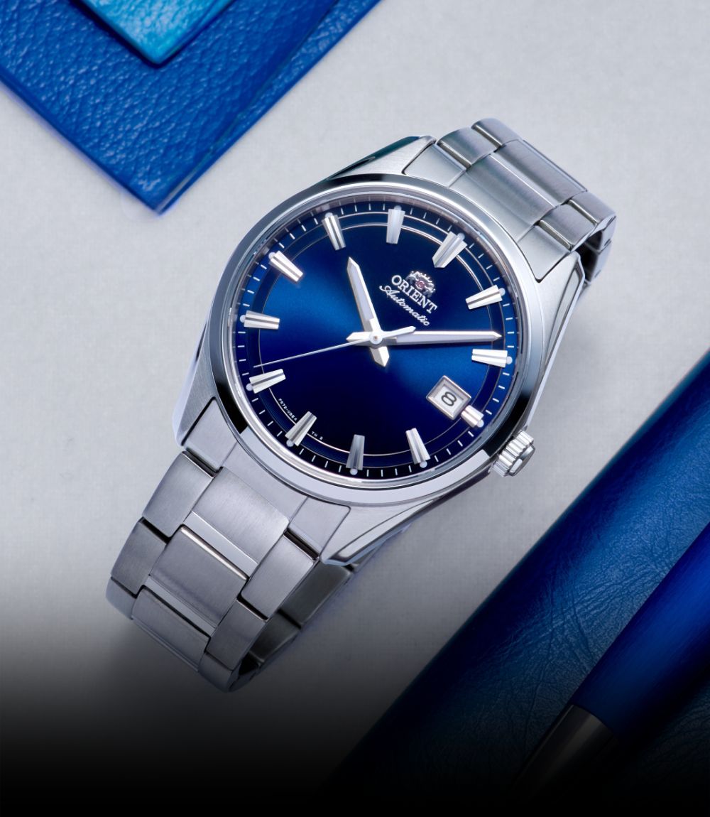 Orient Stretto watch featuring a rich blue sunburst dial and integrated stainless steel bracelet
