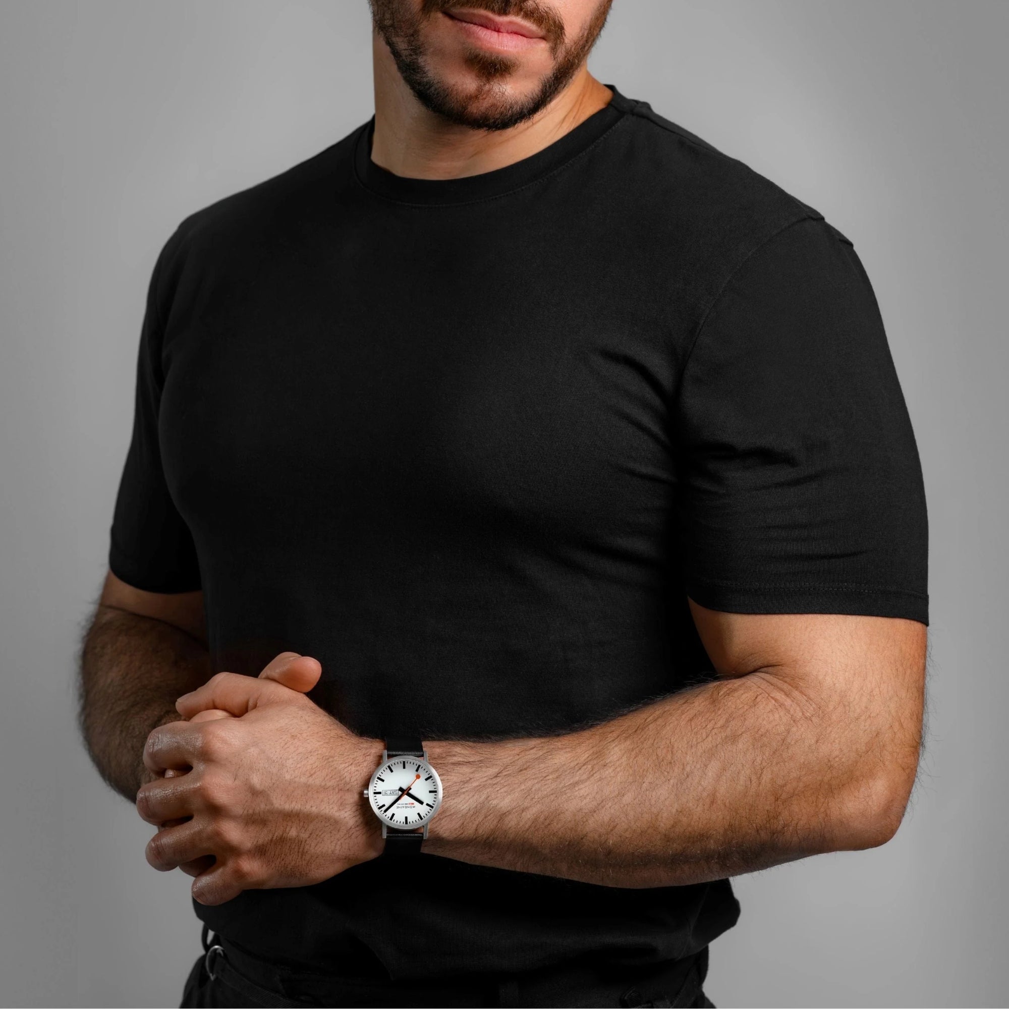 Mondaine Classic A667.30360.11SBBV 40mm mens wrist watch styled on a model wearing a black t-shirt
