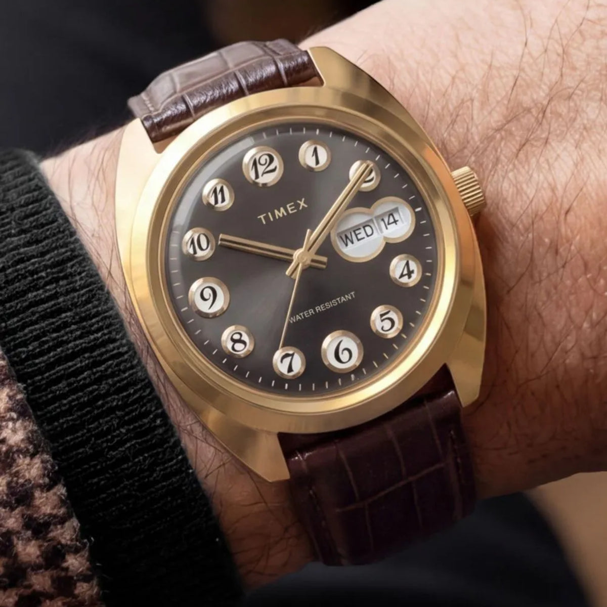 Timex Reissue 1976 Rotary Phone TW2Y82100 wrist view showing black dial quartz watch styled on a person wearing a leather strap