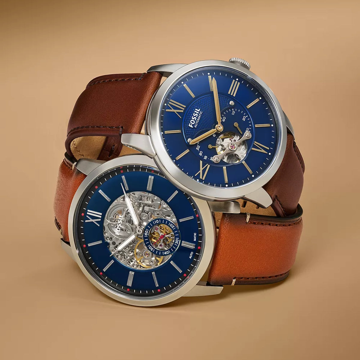 Fossil Townsman ME3110 pair shot showing open heart blue dial model stacked with a blue skeleton automatic watch