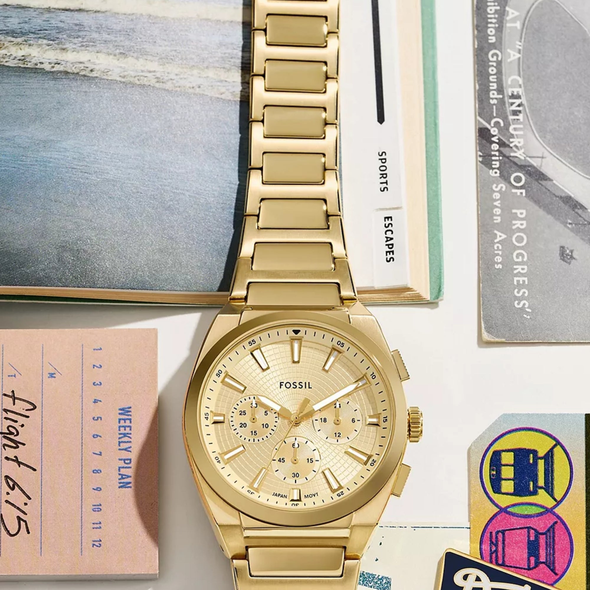 Fossil Everett FS6119 flat lay view with vintage travel books and tickets