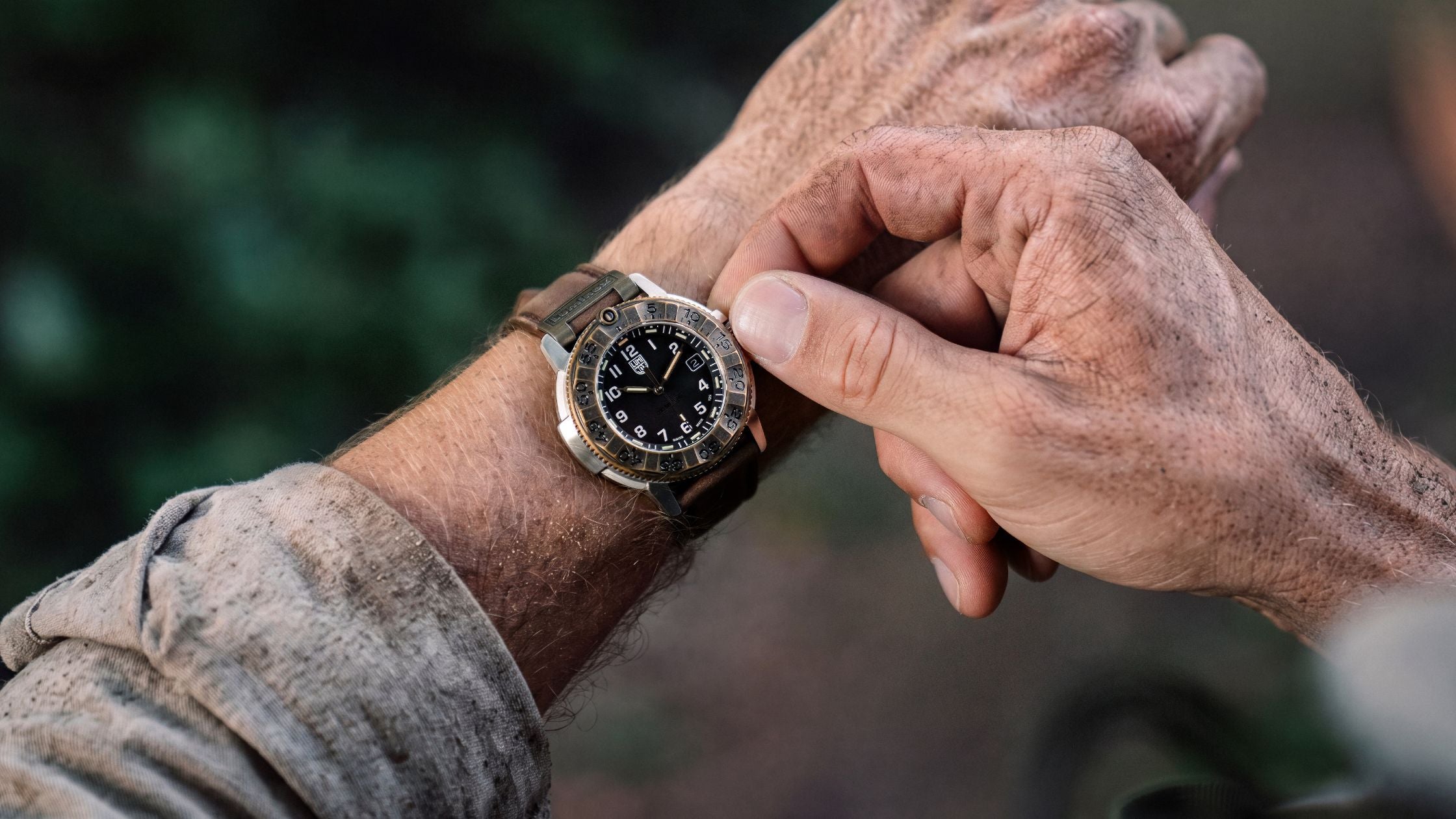 Luminox Adventure Watch XL.1301.LG, with its black dial and brown leather strap on a wrist, highlights its durable design in a natural environment
