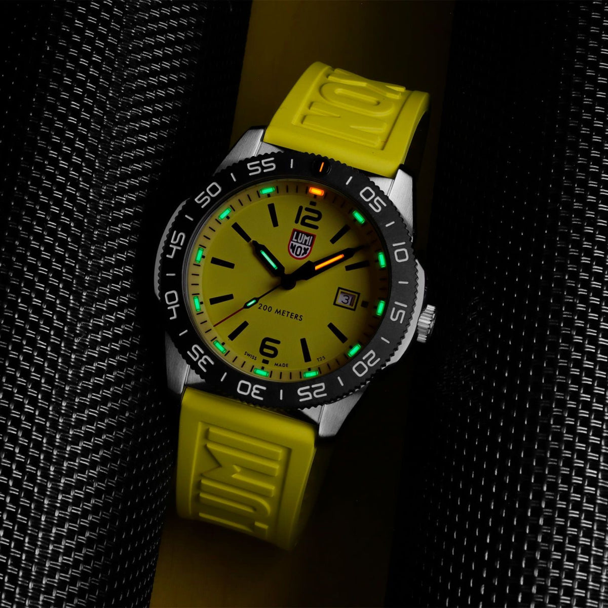 Luminox Pacific Diver 3120 Series XS.3125 night view of illuminated hands and indices against yellow dial surface