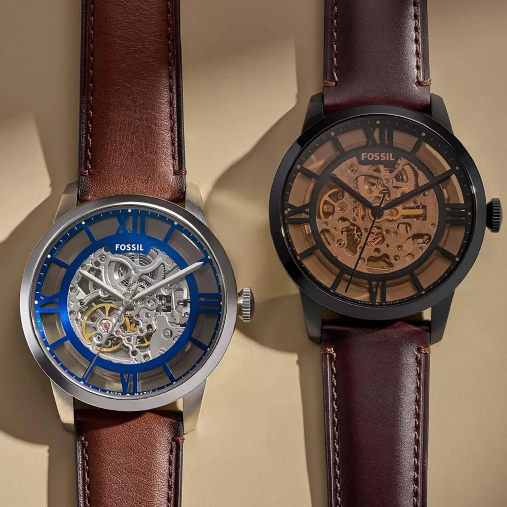 Fossil Townsman 44mm Skeleton Silver Dial Leather Mens Automatic Watch ME3267 compared next to a black and gold variant